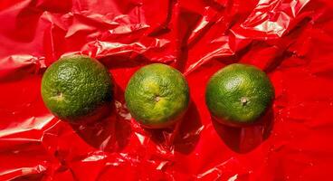 Vibrant Green Limes on Red Foil photo