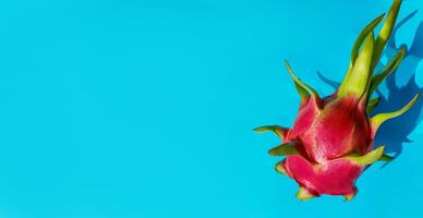 Exotic Red Dragon Fruit on Blue Background   Healthy Lifestyle Concept photo