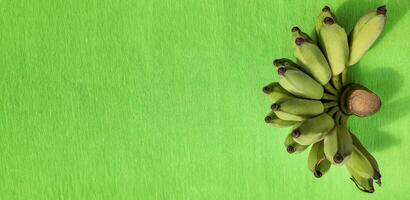 Green Bananas Bunch on Vibrant Backdrop photo