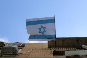 Blue and white flag of Israel with the Star of David in the center. photo