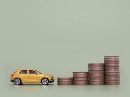 Toy car and stack of coins. The concept of saving money and manage to success transport business photo