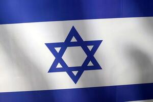 Blue and white flag of Israel with the Star of David in the center. photo