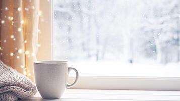 AI generated Winter holidays, calm and cosy home, cup of tea or coffee mug and knitted blanket near window in the English countryside cottage, holiday atmosphere photo