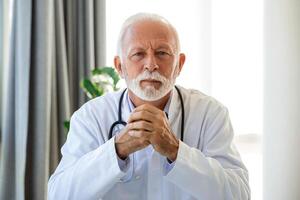 Portrait of senior mature health care professional, doctor, with stethoscope photo