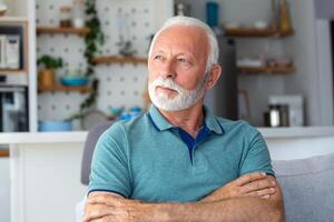 Bored tired sad mature man depressed lonely having no visitors of his children. Divorce , bachelor , health problems concept. Lockdown, unemployment, needless man on social distance photo