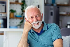 In this captivating close-up, we witness the sheer delight in the eyes of a wise and joyful senior, his face a canvas of wisdom and happiness. photo