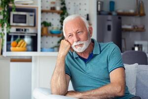 Bored tired sad mature man depressed lonely having no visitors of his children. Divorce , bachelor , health problems concept. Lockdown, unemployment, needless man on social distance photo