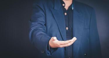 Businessman shaking hands, gesturing success with fingers photo