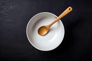 AI generated Top view of an empty white bowl with wooden spoon is served on a dark background photo