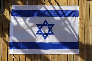 Blue and white flag of Israel with the Star of David in the center. photo