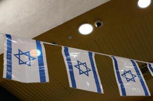 Blue and white flag of Israel with the Star of David in the center. photo