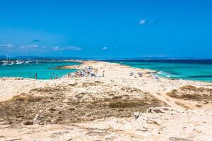 Tourists in Illetes beach Formentera island, Mediterranean sea, Spain photo