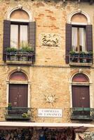 Facades of houses on a street in Venice, Italy photo