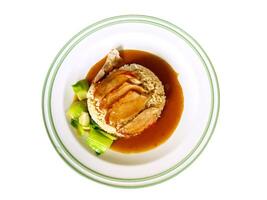 Top view roasted duck on steamed rice with Chinese sauce and boiled vegetables on white ceramic plate isolate on white background and make with paths. photo