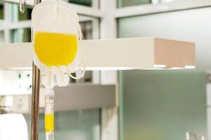 Closeup blood platelet in a medical bag hanging on a pole and transferring to a sick newborn baby at NICU wards in the hospital. photo