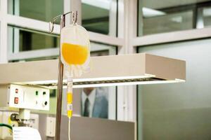 Blood platelet in a medical bag and medical labels hanging on a pole and transferring to a sick newborn baby at NICU wards in the hospital. photo