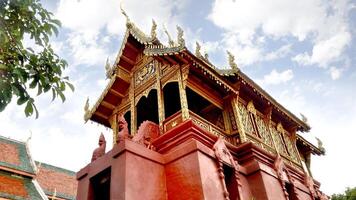 Lamphun city, Thailand, 2017 - Lookup view of Thai temple chapel under blue sky background photo
