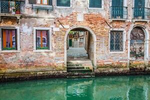 Venetian buildings and boats along Canal Grande, Venice, italy photo