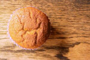 Top view of Thai ancient eggs cupcake put on left of wooden table background with copy space for texts. photo