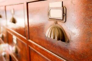 Perspective view and closeup of ancient wooden drawer in Chinese herbs shop. photo