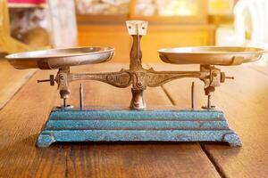 Ancient scales with the weight balance put on wooden table in a Chinese herbs shop and sun flare background. photo