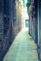 Facades of houses on a street in Venice, Italy photo