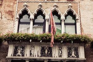 Facades of houses on a street in Venice, Italy photo