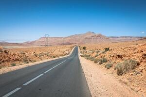 Endless road in Sahara Desert with blue sky,Morocco Africa photo
