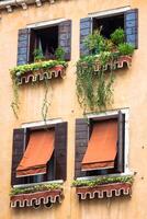 Traditional window of typical old Venice building photo