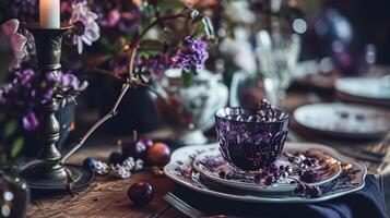 AI generated Dinner table setting in the warm glow of candlelight, tablescape featuring floral centerpiece, elegant burgundy glassware, and luxurious gold cutlery photo