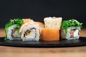 delicious traditional Japanese sushi and rolls on a plate photo