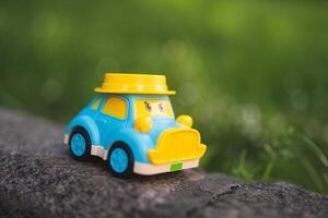 children's plastic toy car with eyes on the playground photo