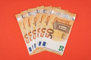 50 euro bills on a red background photo