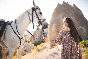 beautiful girl outdoors in the mountains with her faithful horse photo