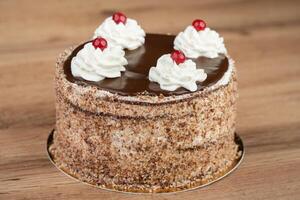 delicious fresh sweet cake with cream and cherry photo