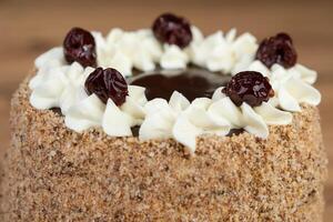 delicious fresh sweet cake with cream and cherry photo