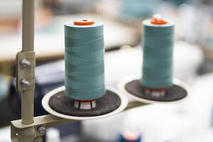 close-up of skeins of thread at an industrial sewing factory for tailoring clothes photo