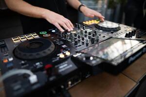 a DJ plays music on a controller at a party photo