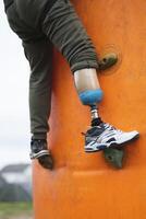 a man with a prosthetic leg does sports climbing on a climbing wall photo