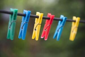 different colors of clothespins for washed clothes on a string photo