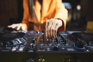 a DJ plays music on a controller at a party photo