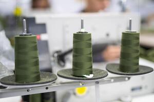 close-up of skeins of thread at an industrial sewing factory for tailoring clothes photo