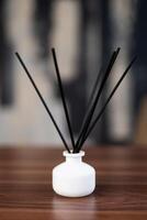 incense sticks in a vase on the table photo
