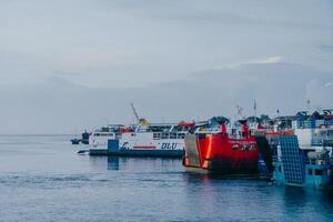 Ferry crossing the Bali Strait at sunrise. Passenger transport ship. Summer and spring holiday concept. Public water transportation. photo