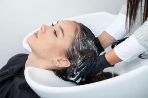 Portrait of a beautiful woman with long brown straight hair in a beauty salon. photo