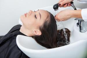 Portrait of a beautiful woman with long brown straight hair in a beauty salon. photo