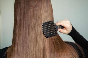 Portrait of a beautiful woman with long brown straight hair in a beauty salon. photo