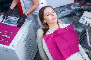 Young Female patient with pretty smile examining dental inspection at dentist clinic. Healthy teeth and medicine, stomatology concept photo