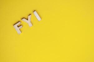 Top view of wooden FYI text on yellow background with customizable space for text photo