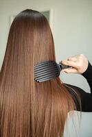 Portrait of a beautiful woman with long brown straight hair in a beauty salon. photo